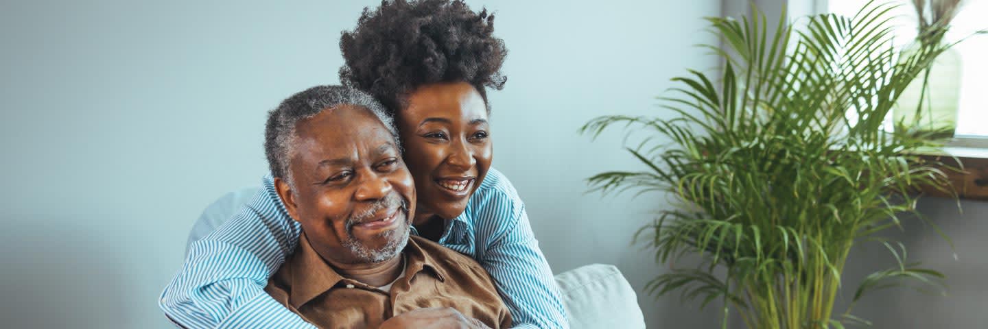 Older man and young woman embracing