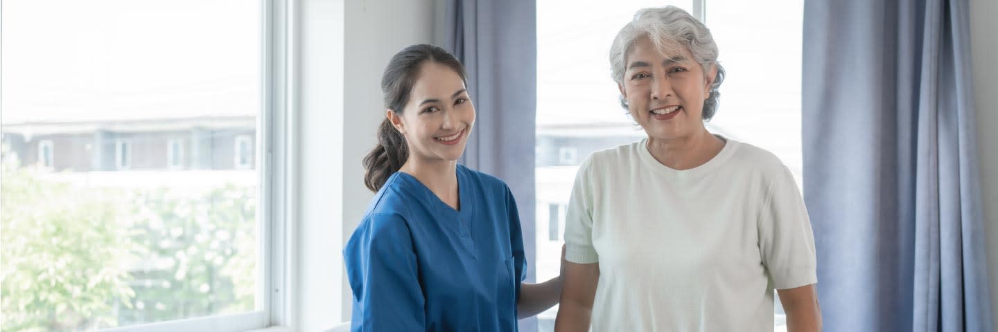 Elderly woman and caregiver